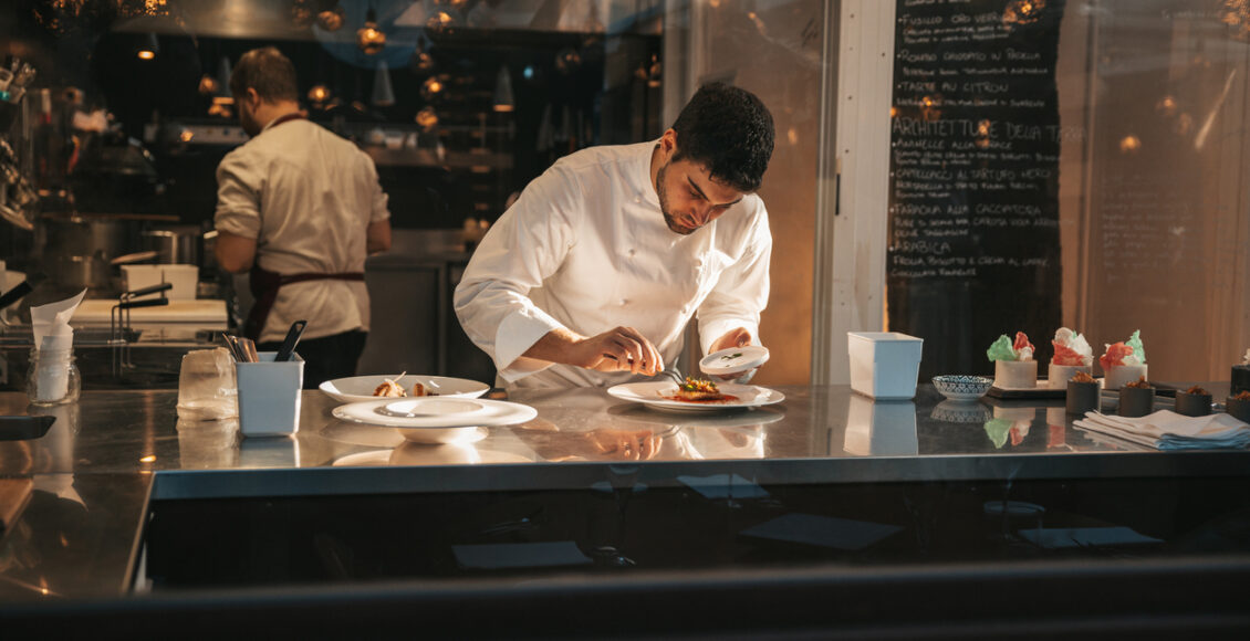 Chef Preparing A Plate In A Gourmet Restaurant