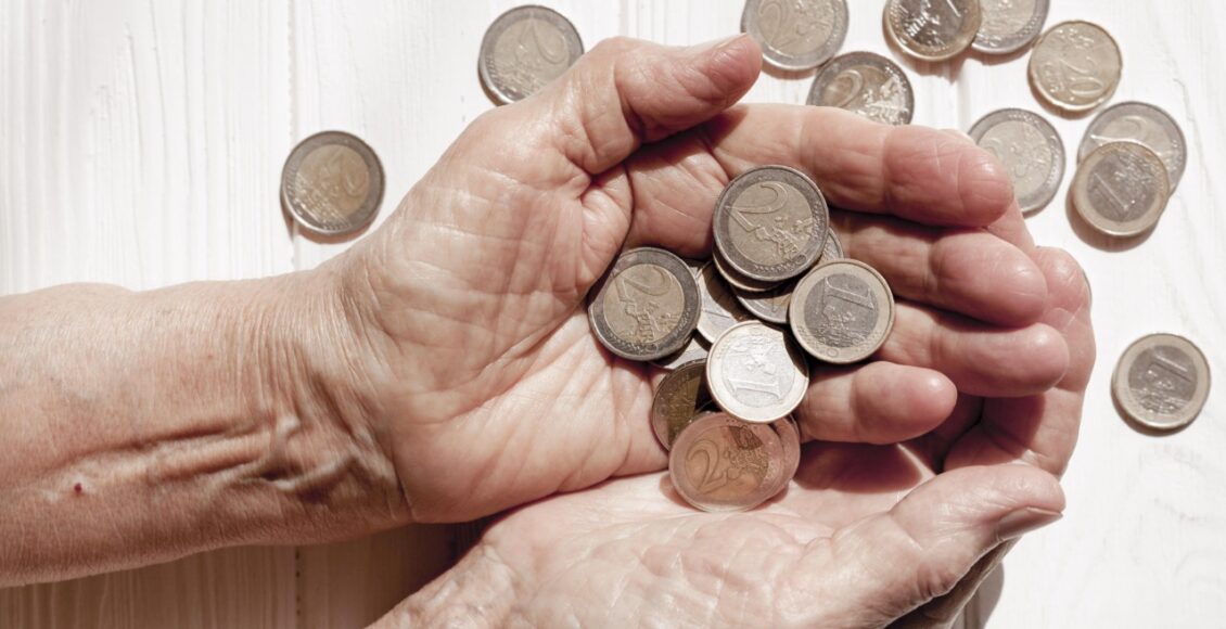 Hand Holding Lots Euro Coins Top View