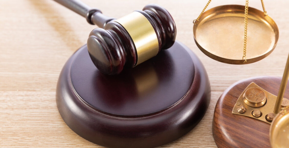 High Angle Shot Of A Gavel And A Scale On A Wooden Surface