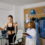 Female Athlete Doing Physical Effort On The Stepper And The Doctor Follows Her