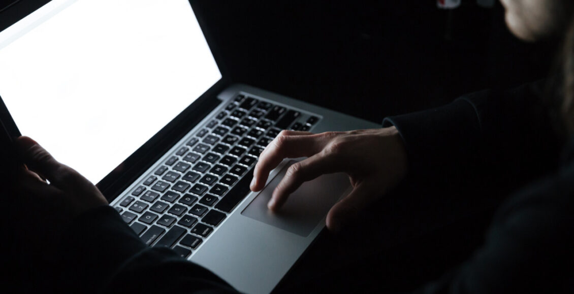 Concentrated Man Using Laptop Computer At Home