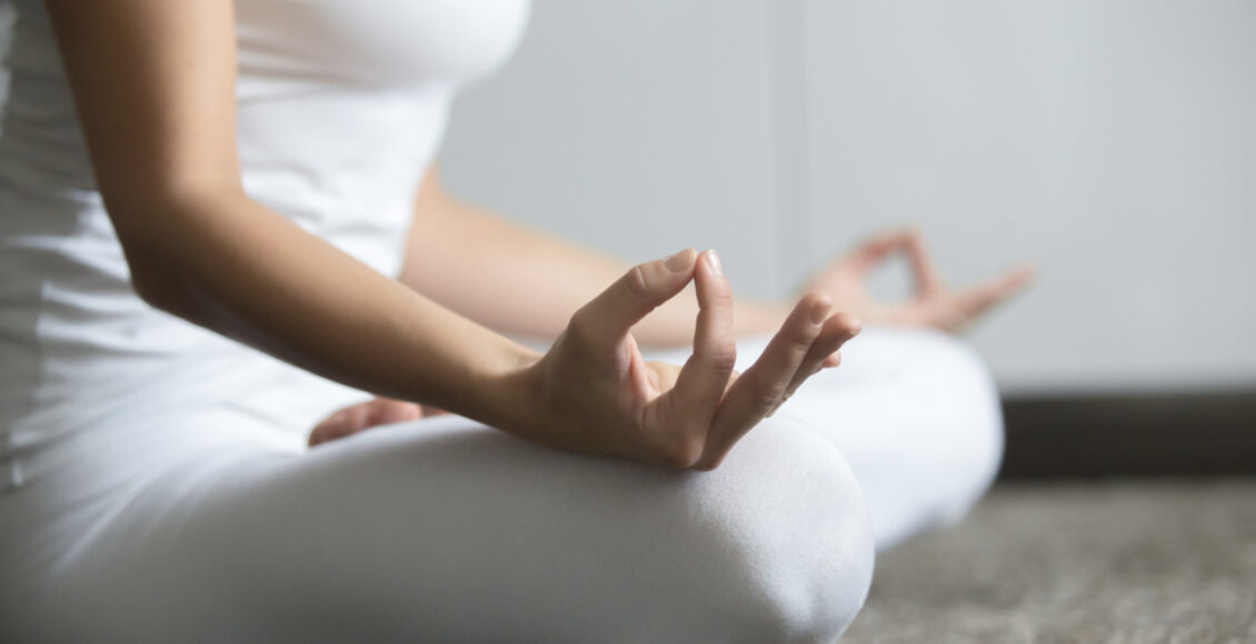 Woman Sitting In Lotus Closeup