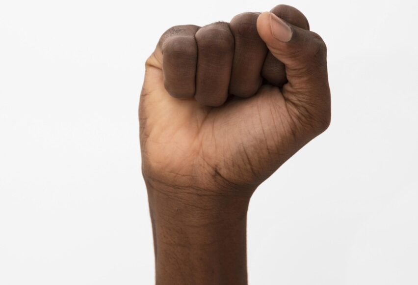 Black Person Holding Their Fist Up