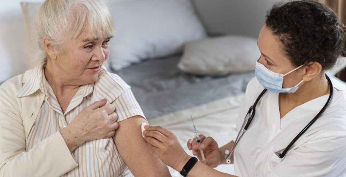 Doctor Preparing Vaccine Senior Woman