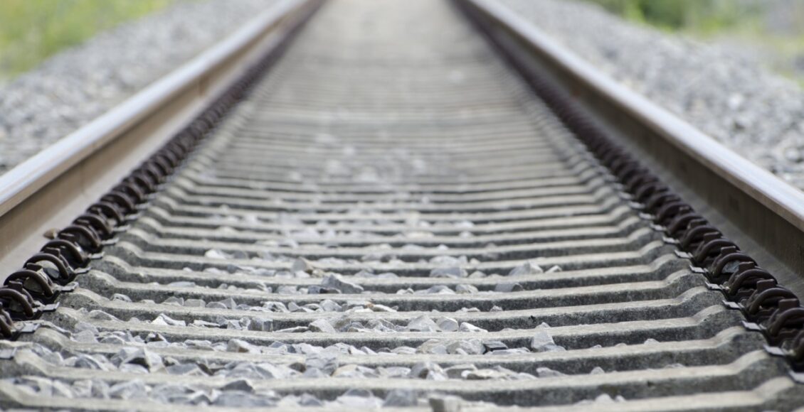 High Angle Shot Of The Old And Rusty Railway Tracks Covered In Small Stones