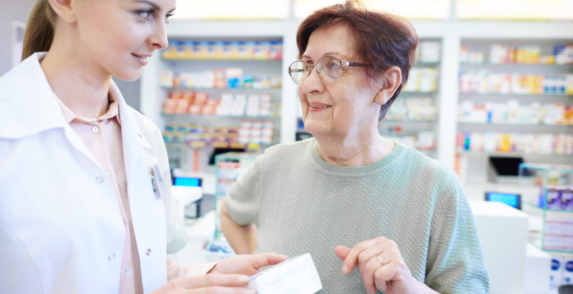 Female Pharmacist Assisting Senior Woman