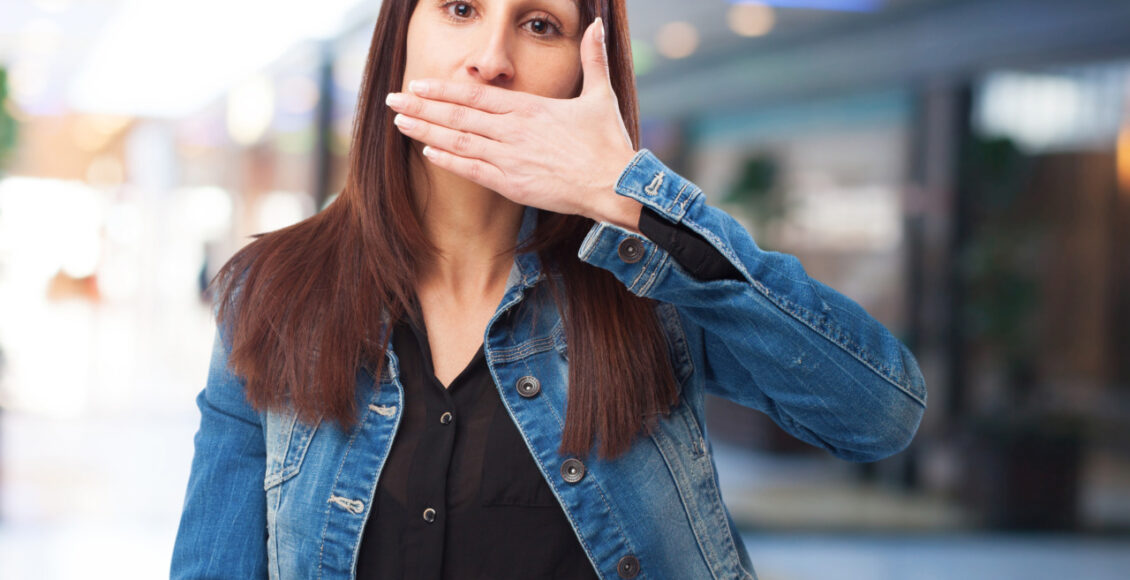 Woman Covering Her Mouth