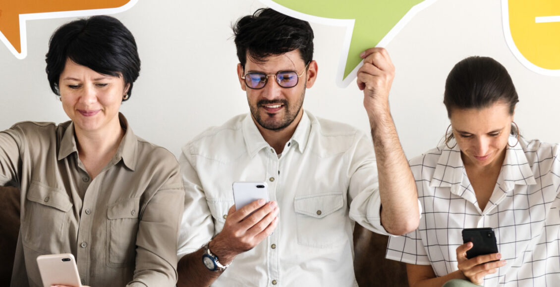 Co Workers Sitting On Couch And Holding Message Icons