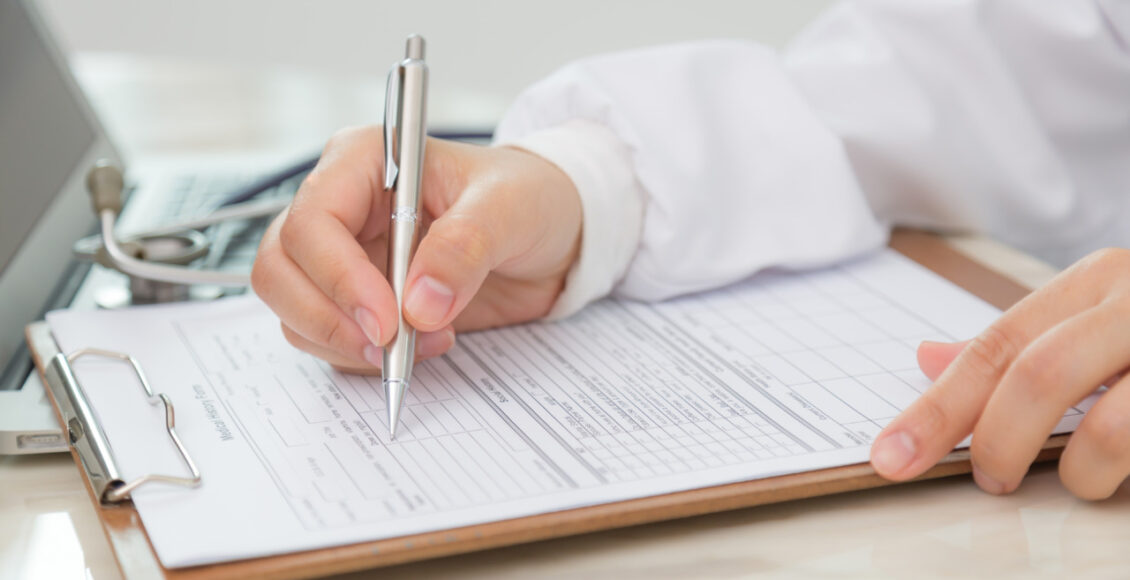 Hand Of Doctor Writing On Prescription