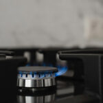 Modern Kitchen Stove, Natural Gas Burns With A Blue Flame. Household Gas Consumption. Close Up, Selective Focus