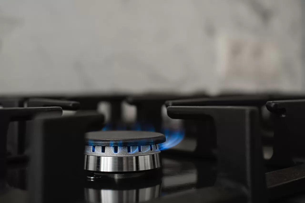 Modern Kitchen Stove, Natural Gas Burns With A Blue Flame. Household Gas Consumption. Close Up, Selective Focus