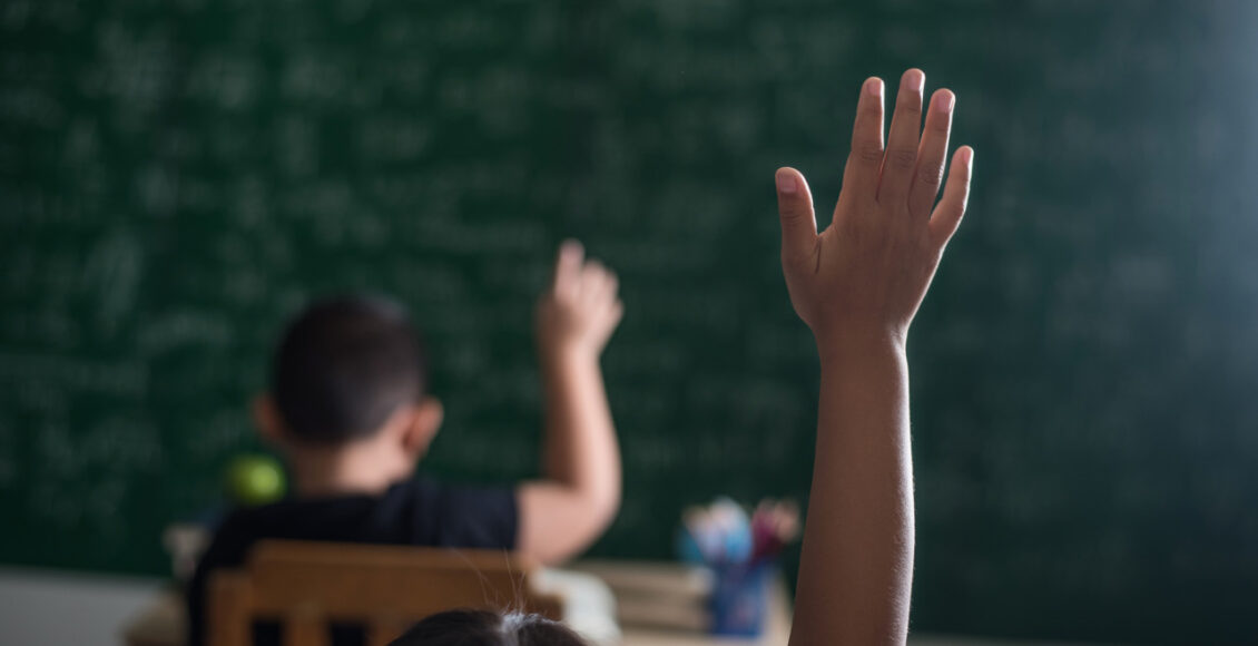 Kid Raising His Hand In Classroom