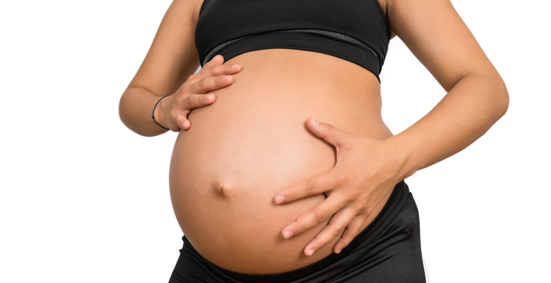 Pregnant Woman Touching Her Big Belly.